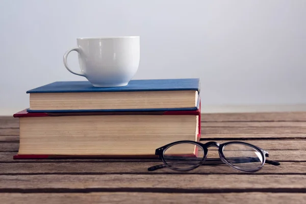 Books with cup of coffee and spectacles — Stock Photo, Image