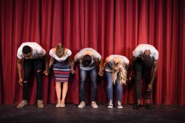 Actors bowing on the stage clipart
