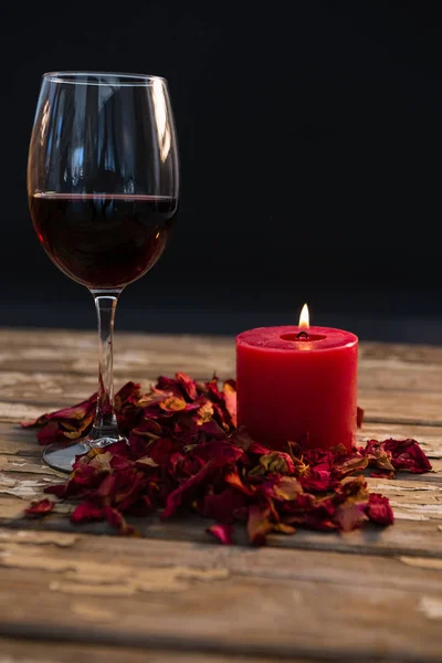 Wineglass by illuminated candle — Stock Photo, Image