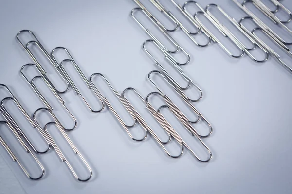 Paper clips arranged on white background — Stock Photo, Image