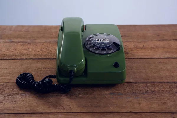 Vintage telefon na dřevěný stůl — Stock fotografie