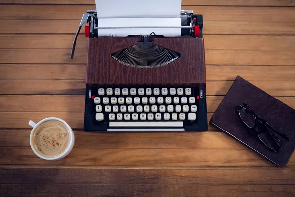 Typewriter by coffee cup and book — Stock Photo, Image