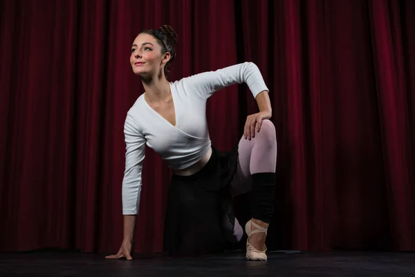 Ballerina performing stretching exercise — Stock Photo, Image