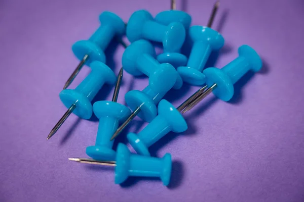 Close up of blue paper pins on paper — Stock Photo, Image