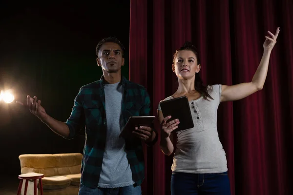 Actors rehearsing on stage while using digital tablet — Stock Photo, Image