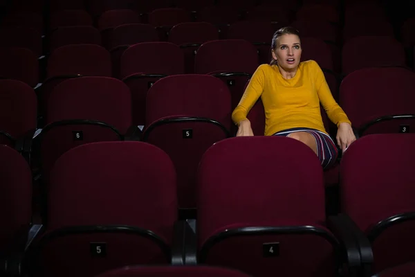 Woman watching movie in theatre — Stock Photo, Image