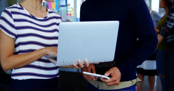 Dirigenti di sesso maschile e femminile discutono su laptop — Video Stock