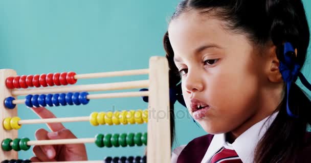 Cute little girl counting on abacus — Stock Video