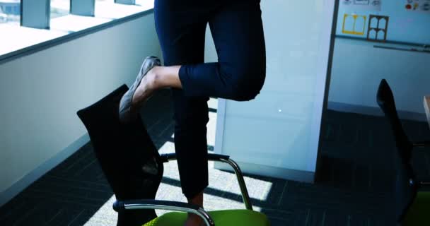 Ejecutiva femenina realizando yoga en su escritorio — Vídeo de stock