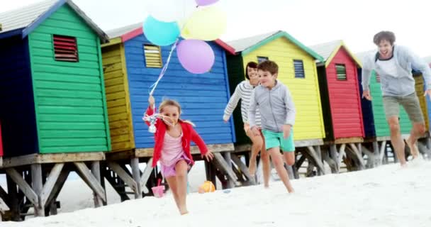 Familia feliz corriendo en la playa — Vídeo de stock