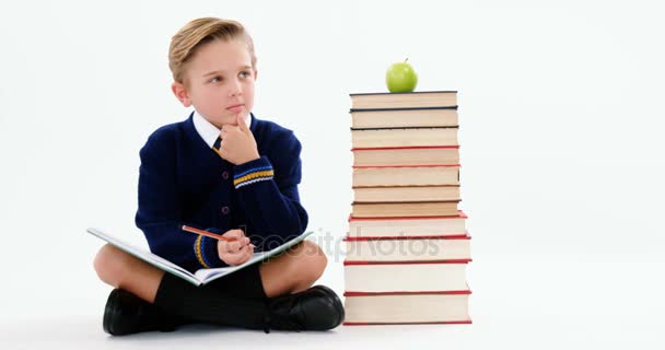 Thoughtful schoolboy doing her homework — Stock Video