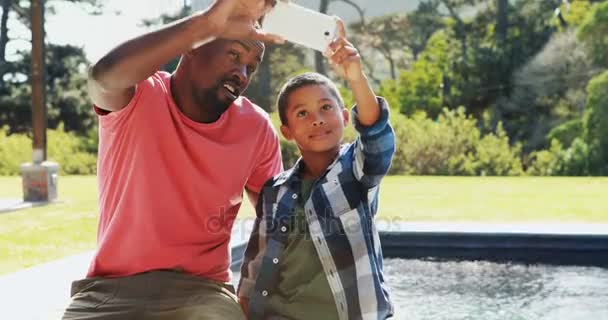 Padre e hijo tomando selfie desde el teléfono móvil — Vídeos de Stock