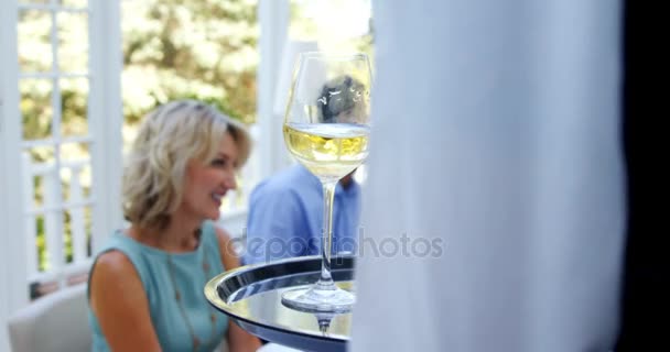 Waiter serving glasses of wine to customer — Stock Video