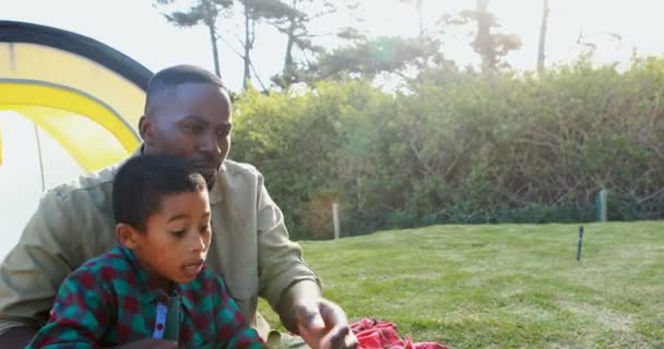 Father teaching son how to catch a fish — Stock Video