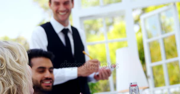 Waiter interacting with customers — Stock Video