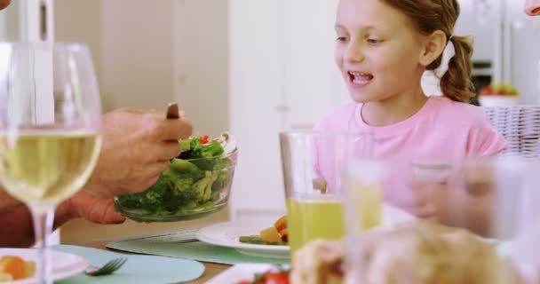 Vader salade serveren met dochter op de eettafel — Stockvideo