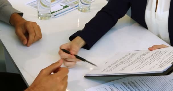 Executive taking sign of colleague on document — Stock Video