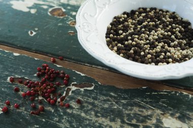 Mix peppercorns on wooden table clipart