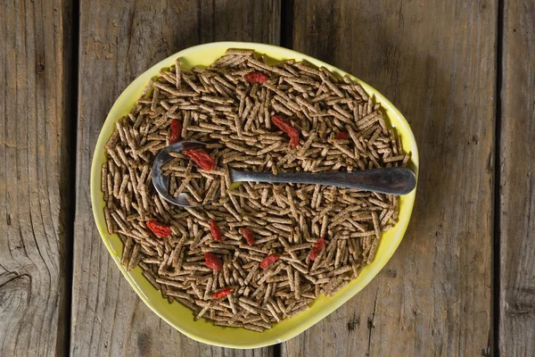 Cereal bran sticks with spoon in plate — Stock Photo, Image