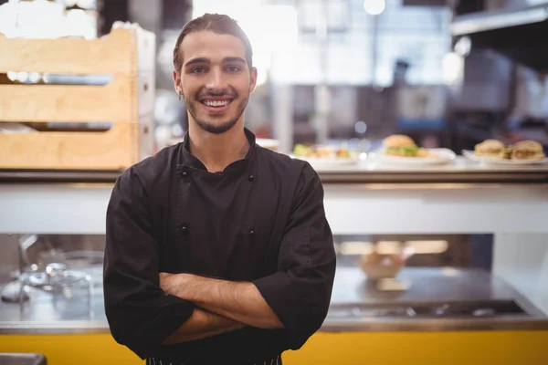 Waiter standing against counter — Stock Photo, Image