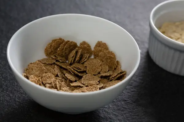 Wheat flakes in bowl — Stock Photo, Image
