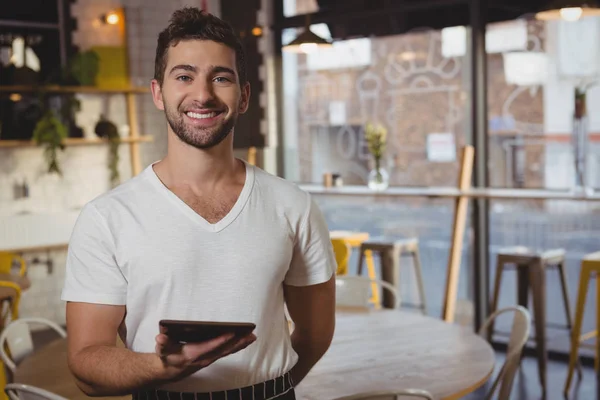 Ober bedrijf tablet in café — Stockfoto