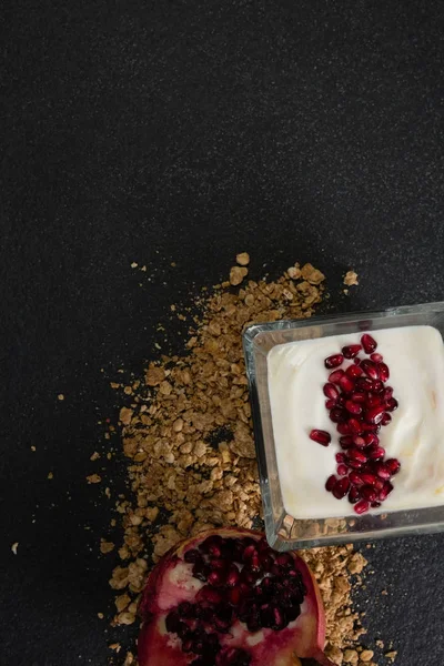 Yogurt with pomegranate slice and granola — Stock Photo, Image