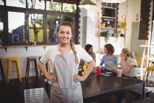 Waitress with hands on hip at cafe — Stock Photo, Image
