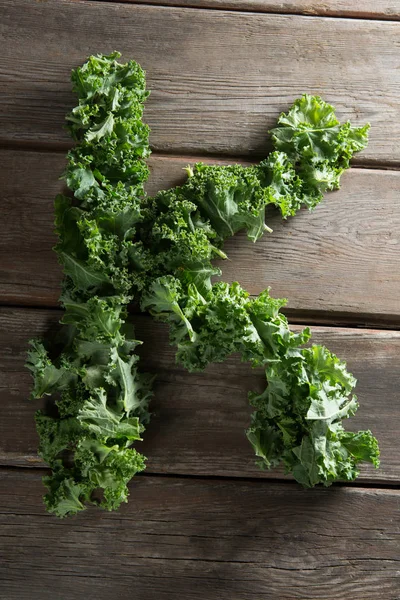 Letter K made with fresh kale leaves — Stock Photo, Image