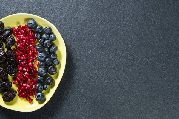 Varias frutas en plato sobre pizarra —  Fotos de Stock