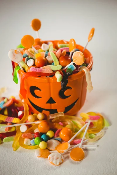 Vista de alto ângulo do balde com vários alimentos doces durante o Halloween — Fotografia de Stock