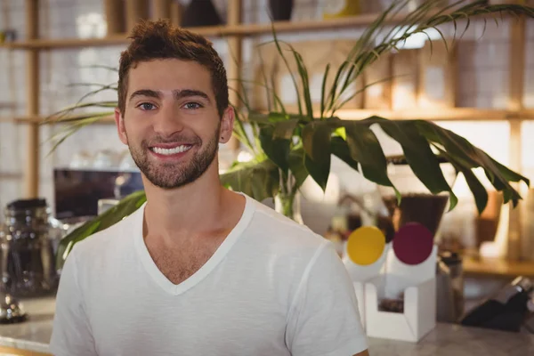 Portrait of man standing at cafe — Stock Photo, Image