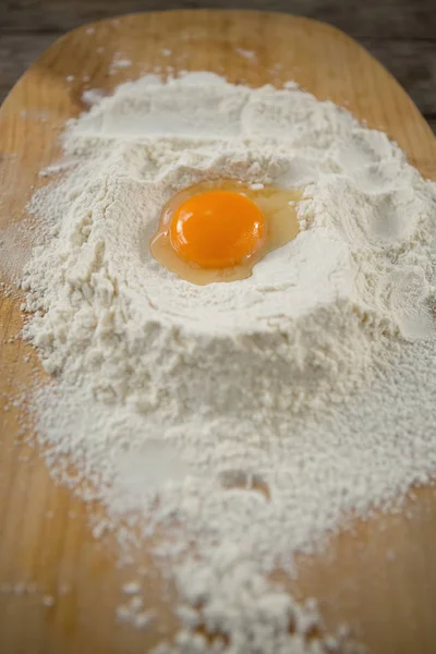 Egg yolk in flour on cutting board — Stock Photo, Image