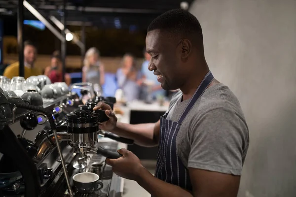 Smiling waiter making cup of coffee — Stock Photo, Image