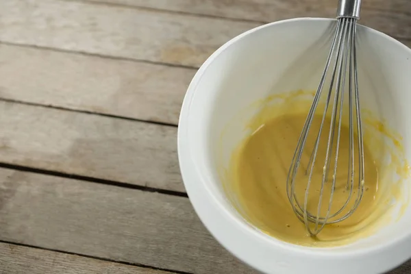 Batter and wire whisk in bowl — Stock Photo, Image