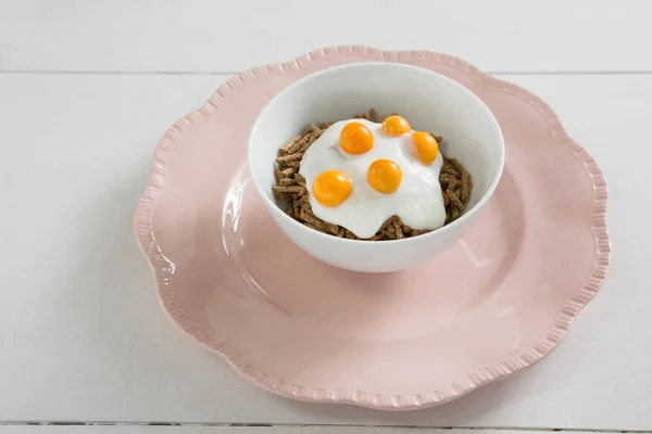 Bowl of cereal bran sticks with yogurt — Stock Photo, Image