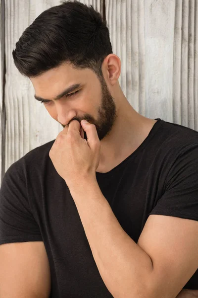 Man posing against wooden background — Stock Photo, Image