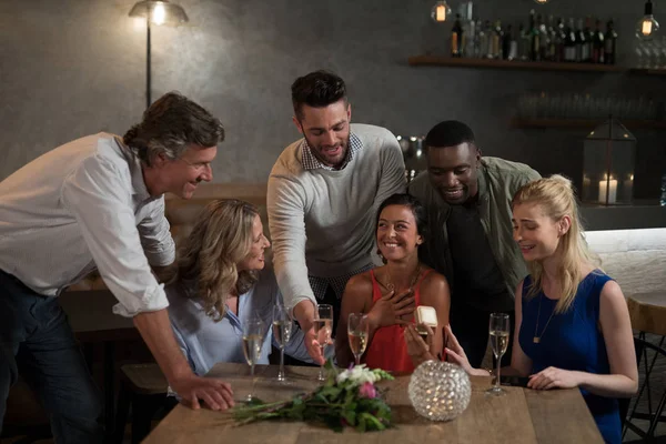 Woman receiving birthday gift form her friends — Stock Photo, Image