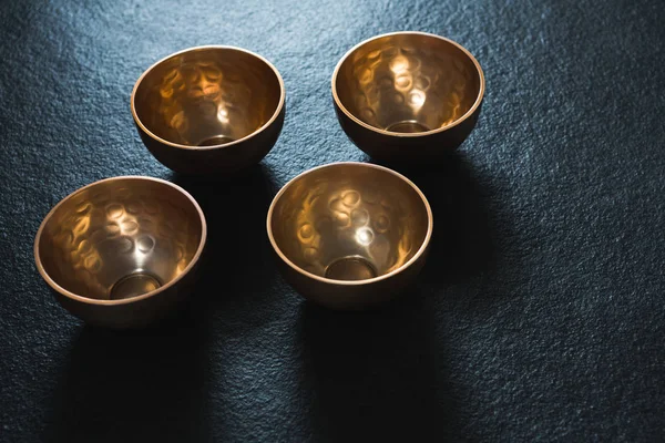 Golden steel bowls on table — Stock Photo, Image