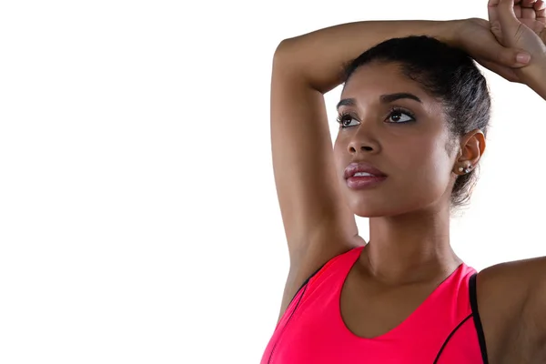 Mujer mirando hacia otro lado mientras hace ejercicio — Foto de Stock