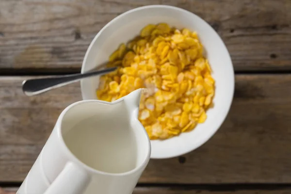 Milk being poured into bowl of wheaties cereal — Stock Photo, Image