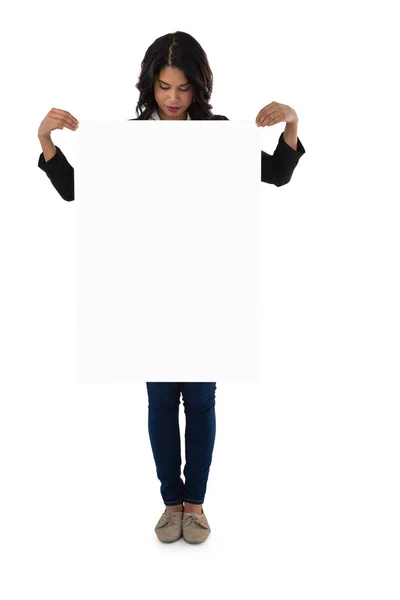 Young businesswoman holding blank placard — Stock Photo, Image