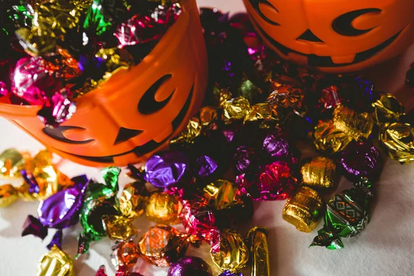 High angle view of orange buckets with colorful chocolates — Stock Photo, Image