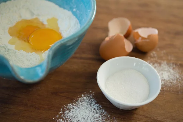 High angle view of egg and flour — Stock Photo, Image