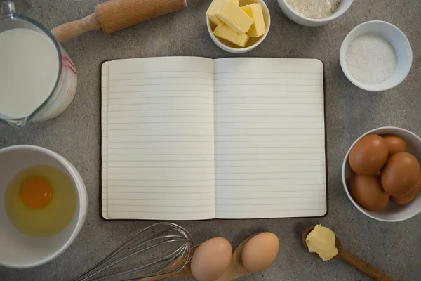 Ingredients amidst open book — Stock Photo, Image