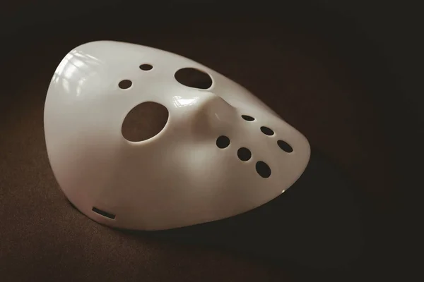 Evil mask over brown background Royalty Free Stock Photos