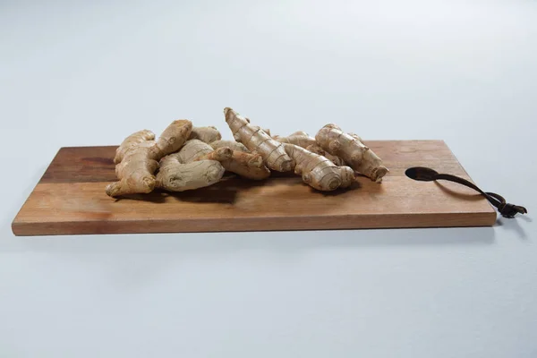 Fresh gingers on wooden serving board — Stock Photo, Image