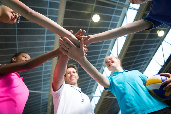 Volleyball players and coach forming hand stack — Stock Photo, Image