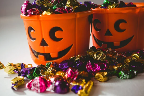 Close up of orange buckets with multicolored chocolates — Stock Photo, Image