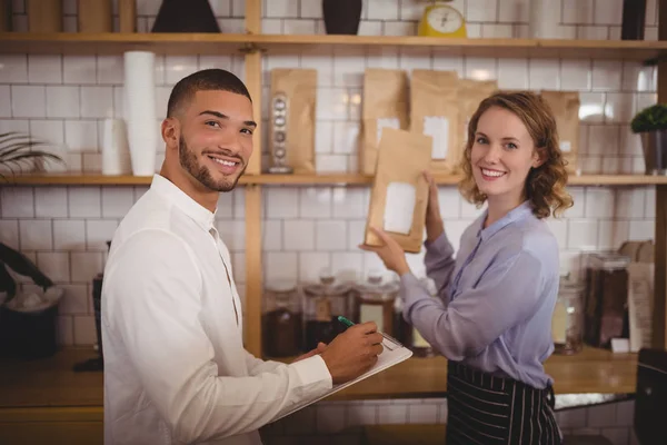 Male owner and waitress arranging packages — Stock Photo, Image